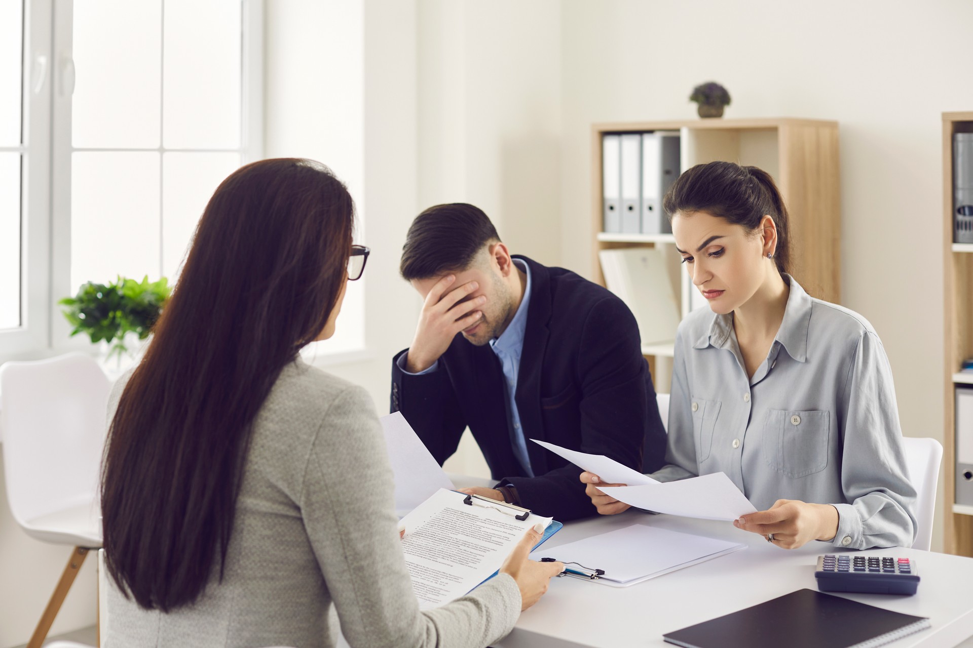 Attorney at desk miscommunicating with client